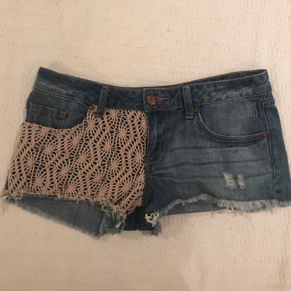 Light wash jean shorts with beige knitted detail